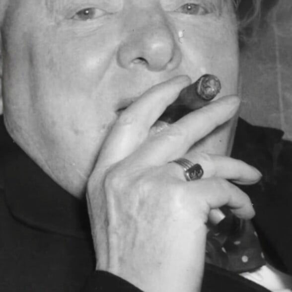 Winston Churchill smoking a cigar, wearing a Signet ring on his ring finger.