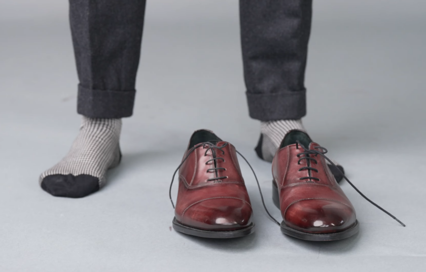 Ivan's rich reddish-brown leather Oxford dress shoes with subtle broguing and patterned socks.