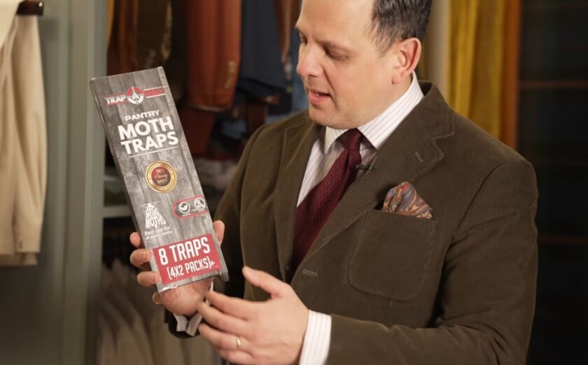 Raphael in a corduroy jacket holding a box of Trap A Pest Pantry Moth Traps