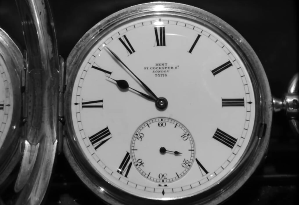 A close-up image of a pocket watch.