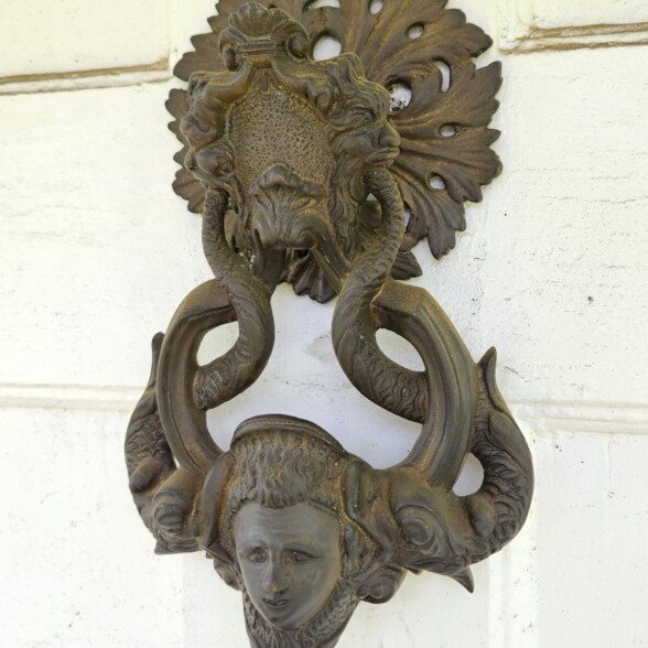 20260605 101225 Solid bronze door knocker on a white door