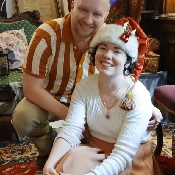 471470693 10162049516404904 1910800421972935696 N Eb poses wearing a knit shirt with his wife at Christmastime