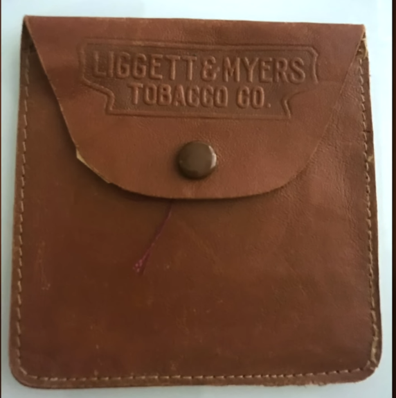 Leather Tobacco Pouch A vintage brown leather tobacco pouch with a snap button closure, embossed with the words "Liggett & Myers Tobacco Co." on the top flap