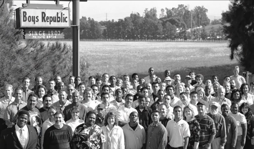 Black and white group photo of students and staff standing in front of the Boys Republic sign in Chino, California, established 1907