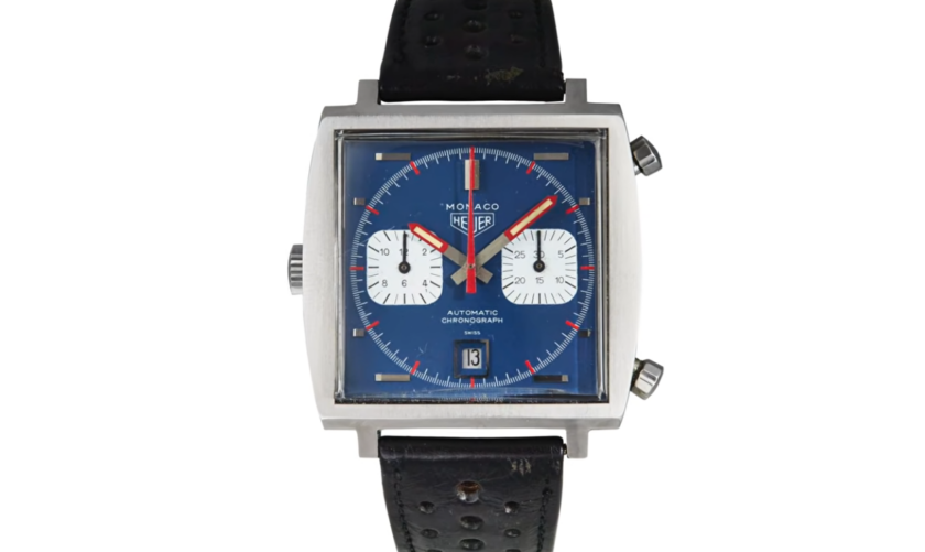 Vintage Heuer Monaco Ref. 1133 with blue dial, square stainless steel case, red chronograph hands, white sub-dials, and black perforated leather strap