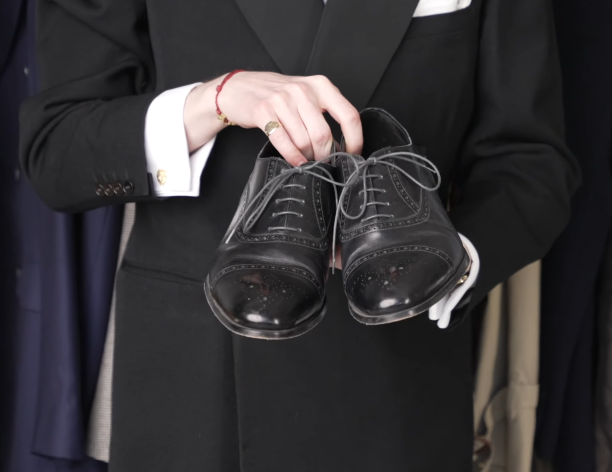 Black Quarter Brogue Cap Toe Oxford Shoes Jack Collins holding a pair of black leather quarter brogue oxford shoes with punched cap-toe detailing