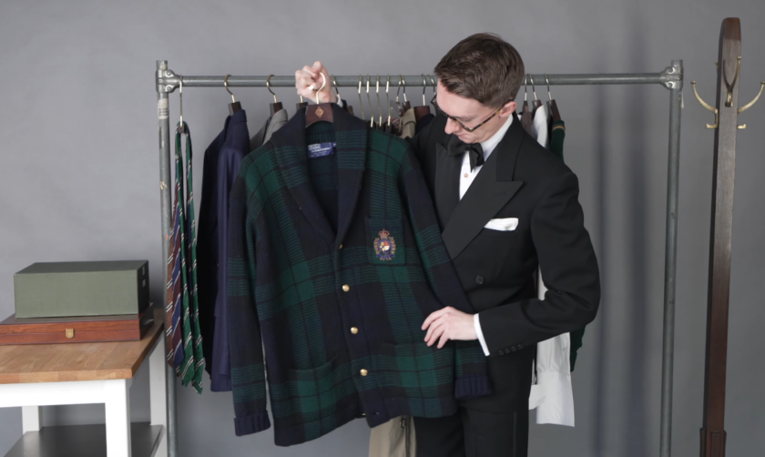 Black Watch Tartan Shawl Cardigan Brass Buttons Jack Collins holding up a green and navy Black Watch tartan shawl collar cardigan with brass buttons and a crest on the chest