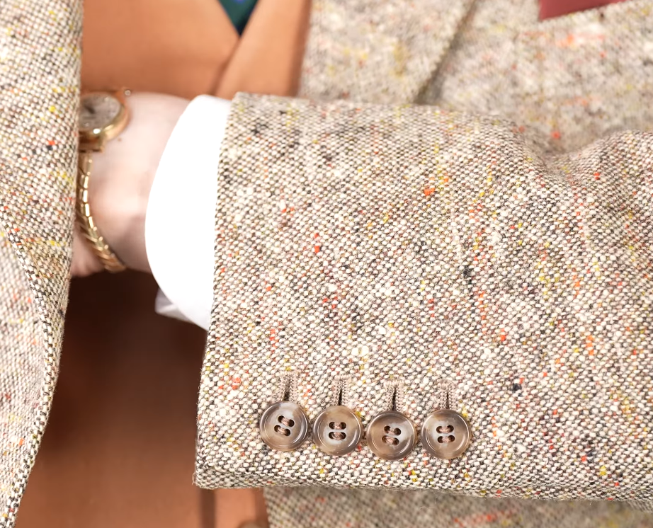 Donegal Tweed Oatmeal Sport Coat Cuff Oatmeal Donegal tweed sport coat sleeve with four horn cuff buttons and multicolored nepps, worn with a white shirt cuff and gold watch