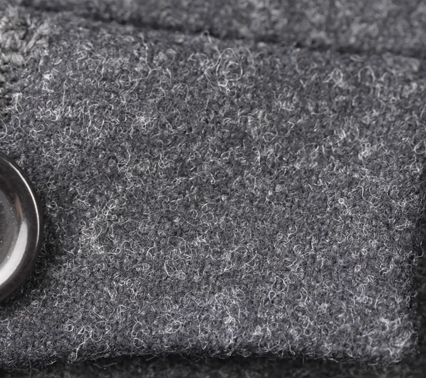 Worsted Flannel Charcoal Nap Close Up Extreme close-up of charcoal flannel showing the raised fuzzy nap and mélange of light and dark gray fibers running through the cloth